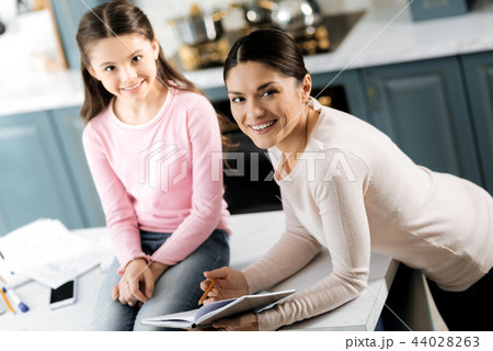 Beautiful loving woman explaining girl home assignment 44028263