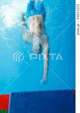 Photo on top of young sporty man swimming on back in swimming pool Photo on top of young sporty man swimming on back in swimming pool 44031252