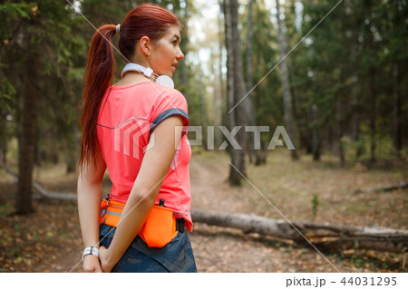 Image from back of young sportswoman standing in forest 44031295