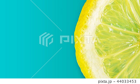 Macro fresh slice of  lemon on cyan background 44033453
