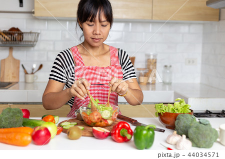 Healthy food Asian woman is cooking salad Healthy food Asian woman is cooking salad 44034571
