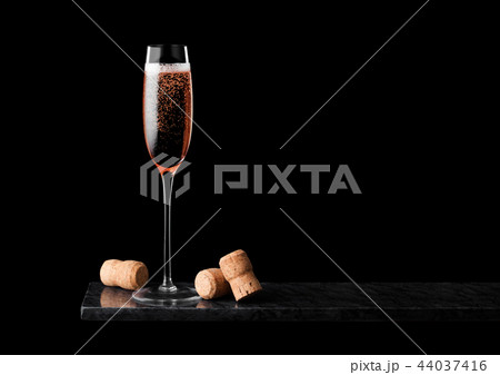 Elegant glass of pink rose champagne with corks Elegant glass of pink rose champagne with corks 44037416
