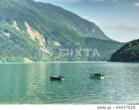 The incredibly magic green lake with fishing boats 44037626