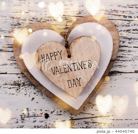 Heart composition for Valentine Day. Wooden hearts on old white desk. 44040740