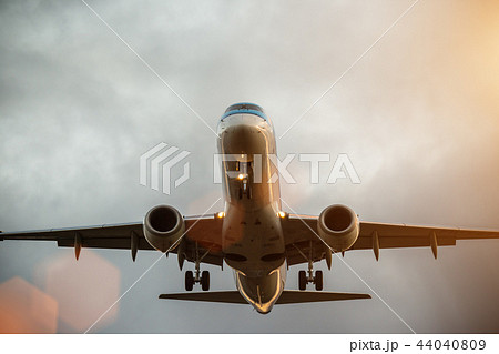 Commercial airplane flying above clouds. 44040809