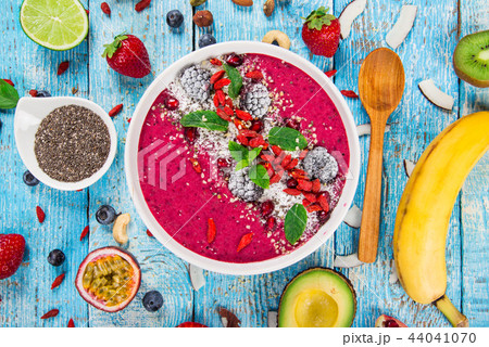 Smoothie bowl with fresh berries, nuts, seeds, fruit and vegetables. Smoothie bowl with fresh berries, nuts, seeds, fruit and vegetables. 44041070