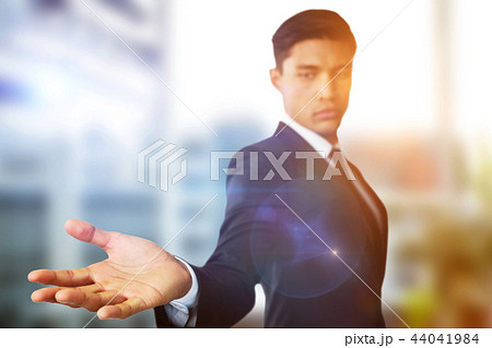 Composite image of confident businessman showing hand against white background Composite image of confident businessman showing hand against white background 44041984