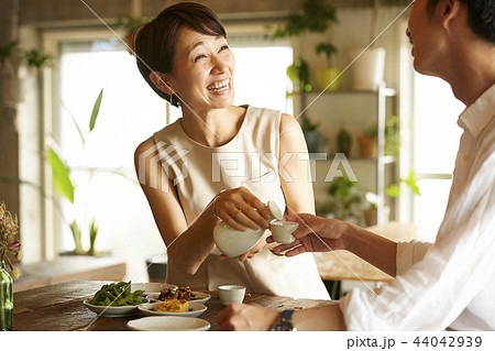 部屋でお酒を飲む男女 44042939