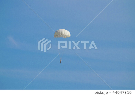 The parachutist flying in a blue sky  44047316