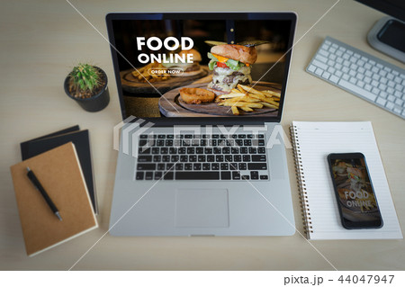 Close up woman ordering food online by internet Close up woman ordering food online by internet 44047947