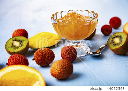 Jam of tropical fruits on a wooden table. Jam of tropical fruits on a wooden table. 44052563