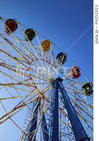 Ferris wheel against the blue sky. Ferris wheel against the blue sky. 44052623
