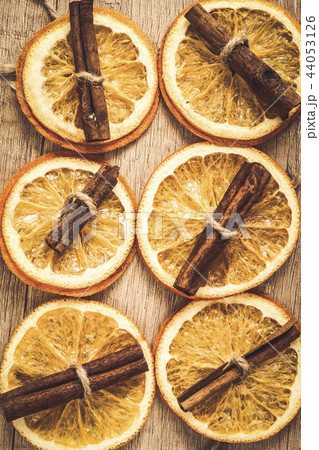 background of dried orange and cinnamon sticks background of dried orange and cinnamon sticks 44053126