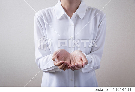 Female Hand Holding Something Stock Photo