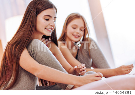 Attractive girls being busy while doing pedicure Attractive girls being busy while doing pedicure 44054891