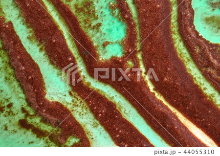 Green and brown abstract curve strips of melted ice cream. Summer background close-up. 44055310