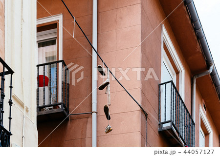 Shoes hanging on wire in Lavapies in Madrid Shoes hanging on wire in Lavapies in Madrid 44057127
