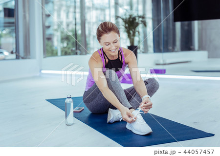 Glad mature woman getting dressed before workout 44057457