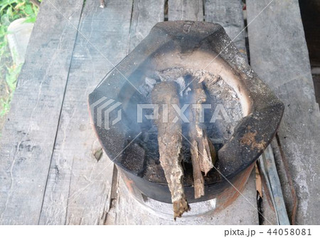 Fireplace for cooking is burning firewood. 44058081