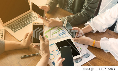 people working or play on smart phone under warm l 44059083
