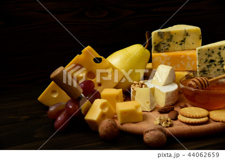Various types of cheese on a rustic wooden table Various types of cheese on a rustic wooden table 44062659