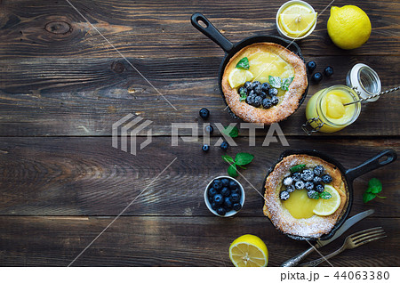 Dutch Baby pancake with lemon curd and blueberries 44063380