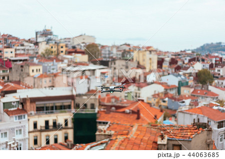Drone flying above old city, selective focus Drone flying above old city, selective focus 44063685