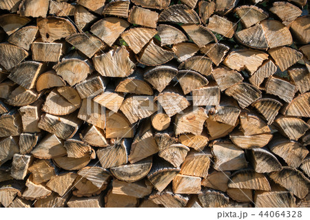 Cut split stacked firewood for winter background close-up Cut split stacked firewood for winter background close-up 44064328