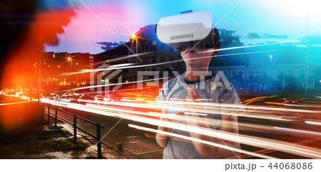Composite image of boy gesturing while using virtual reality headset 44068086