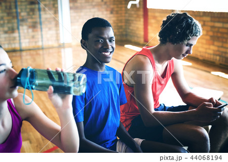 High school kids relaxing on bench 44068194
