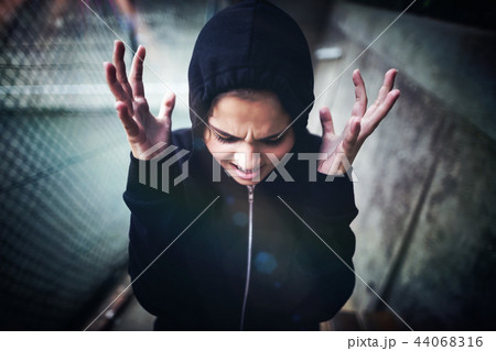 Angry teenage girl standing at school campus 44068316