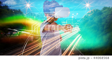 Composite image of boy using virtual reality headset while gesturing Composite image of boy using virtual reality headset while gesturing 44068568