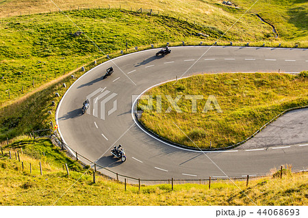 Motorcycle drivers riding in Alpine highway on famous Hochalpenstrasse, Austria, Europe. Motorcycle drivers riding in Alpine highway on famous Hochalpenstrasse, Austria, Europe. 44068693