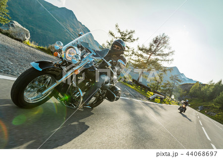 Motorcycle drivers riding in Alpine highway on famous Hochalpenstrasse, Austria, Europe. Motorcycle drivers riding in Alpine highway on famous Hochalpenstrasse, Austria, Europe. 44068697