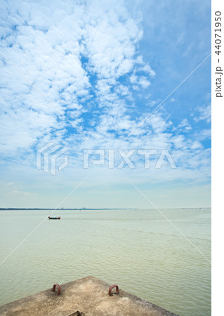 Cloudy blue sky and minimal boat Cloudy blue sky and minimal boat 44071950
