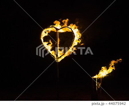 Yellow burning handmade heart on black background 44075942