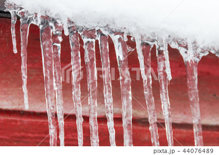 Icicles hanging from roof Icicles hanging from roof 44076489