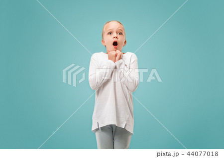 Portrait of the scared girl on blue Portrait of the scared girl on blue 44077018