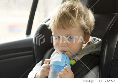 Portrait of cute toddler boy sitting in car seat. Child transportation safety. Adorable baby boy Portrait of cute toddler boy sitting in car seat. Child transportation safety. Adorable baby boy 44078457