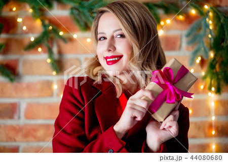 girl in red coat with gift box girl in red coat with gift box 44080680