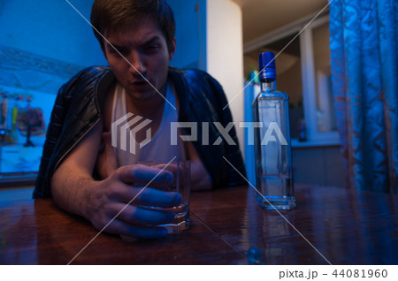 Alcohol addicted man sitting in kitchen at home. 44081960