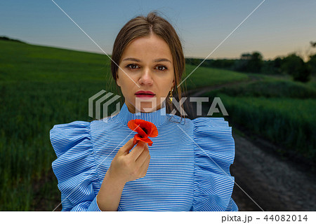 Holding a red poppy. Holding a red poppy. 44082014
