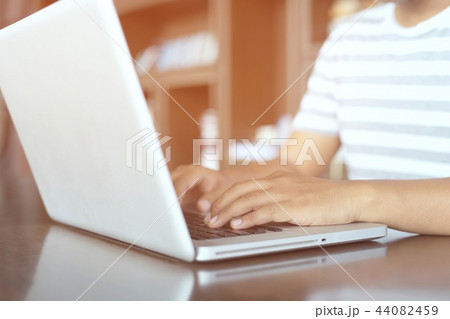 young woman working on his laptop young woman working on his laptop 44082459