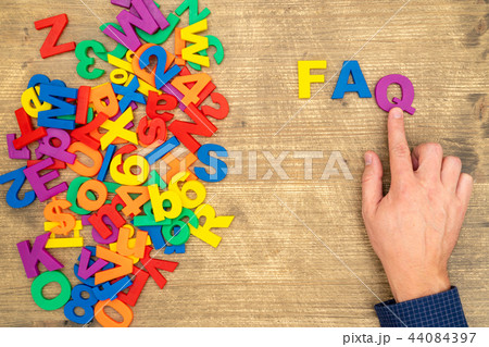 Hand arrange plastic letters as FAQ abbreviation 44084397