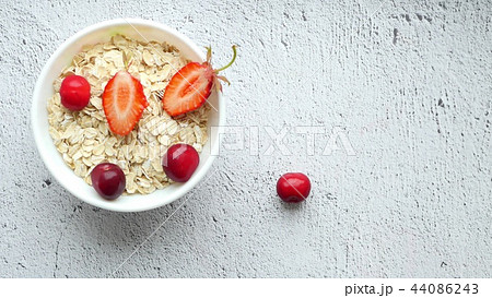 Beautiful female hands lay out on the table a composition of bright berries - 4. Juicy red cherries Beautiful female hands lay out on the table a composition of bright berries - 4. Juicy red cherries 44086243