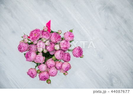Garden flowers over grey wooden table background. Backdrop with copy space Garden flowers over grey wooden table background. Backdrop with copy space 44087677