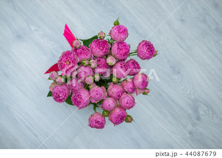 Garden flowers over grey wooden table background. Backdrop with copy space Garden flowers over grey wooden table background. Backdrop with copy space 44087679