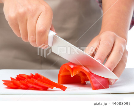 Cook is chopping bell pepper Cook is chopping bell pepper 44088095