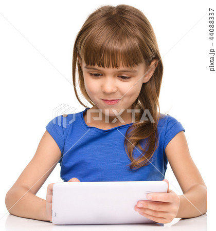 Young girl is using tablet Young girl is using tablet 44088337