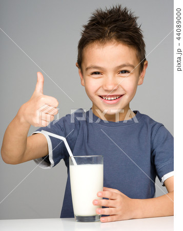 Cute boy with a glass of milk Cute boy with a glass of milk 44089000